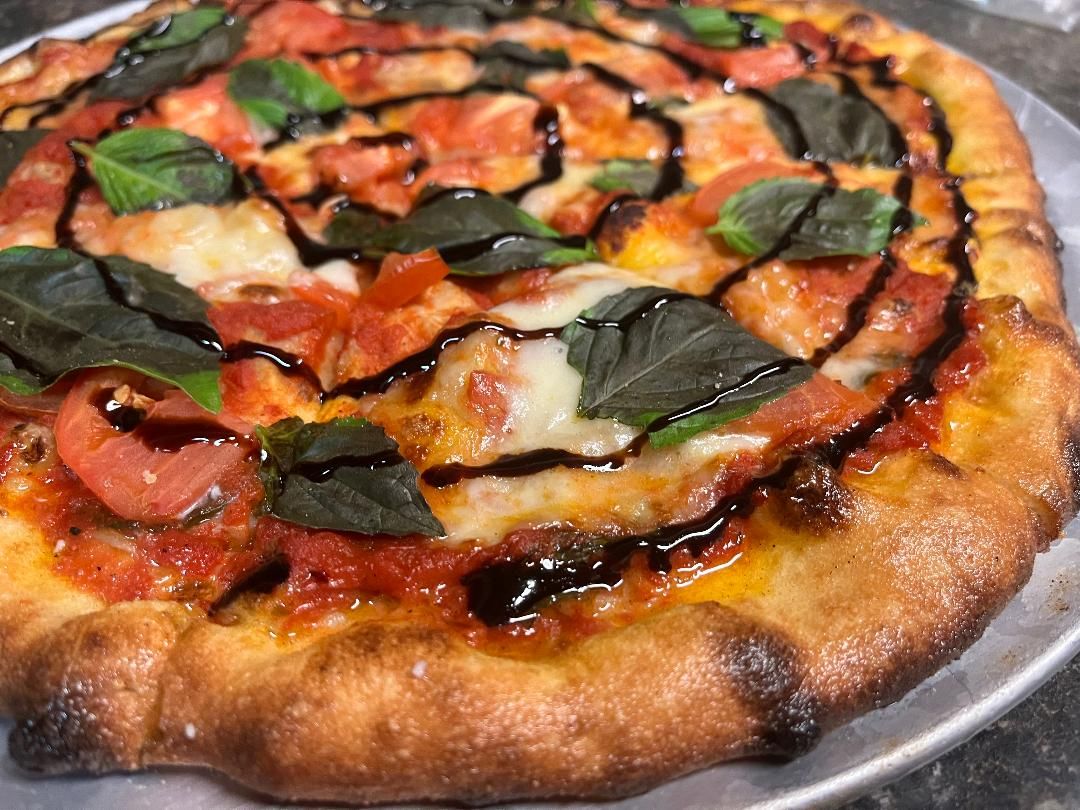 Wood-fired pizza with fresh basil, mozzarella and balsamic glaze